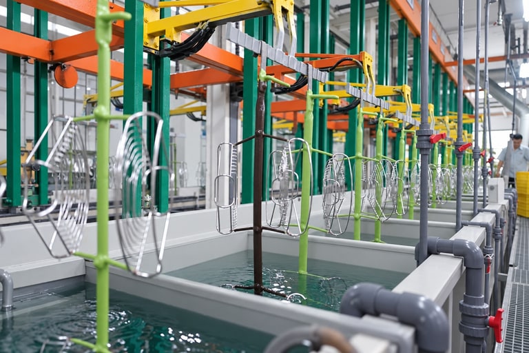 Surface-treatment line with suspended metal components