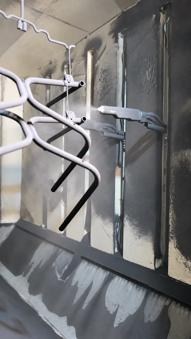 Automatic powder coating of chair frames